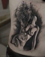 Black and white tattoo of girl with wolf by tattoo artist Alexei Mikhailov @mikhailovtattoo