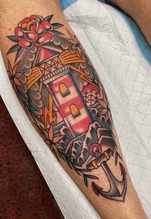 Old school lighthouse and anchor on calf. 