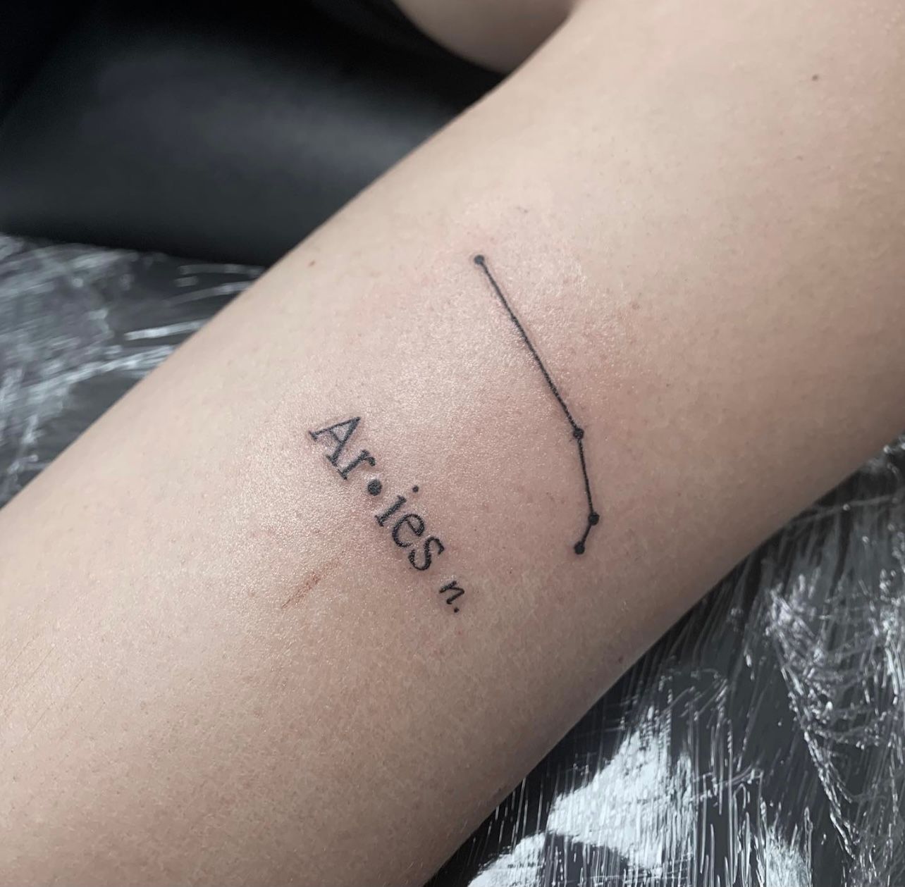 Aries constellation tattoo forming the word SEA