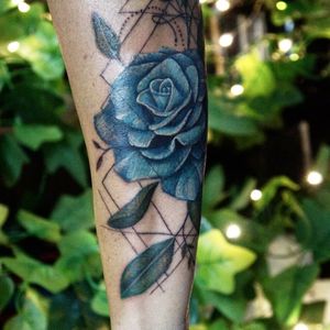 Realistic coloured flower with geometry tattoo. 