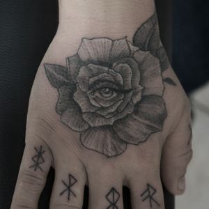 Third eye in a rose flower surrealistic tattoo 