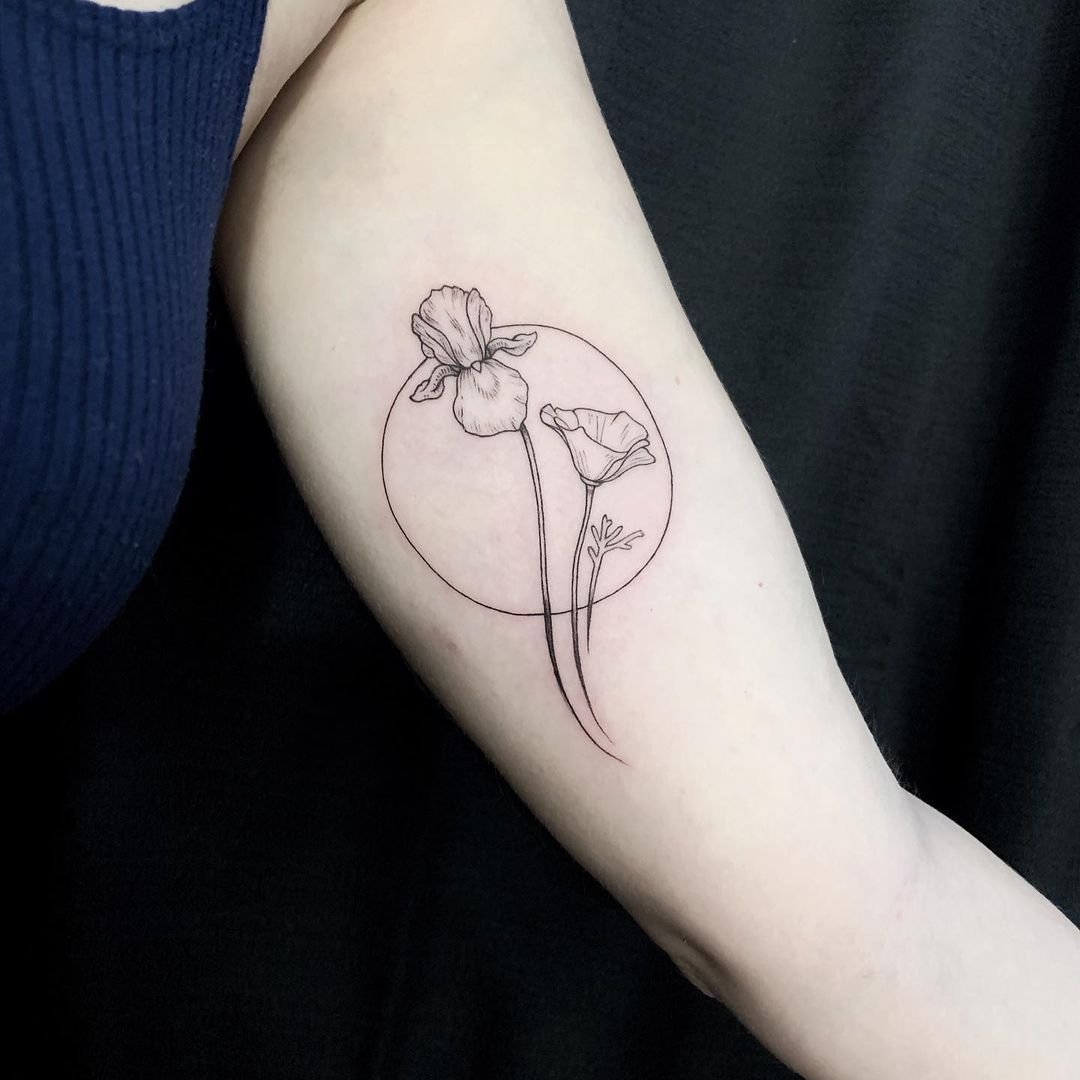 Fine line iris flower tattoo on the forearm