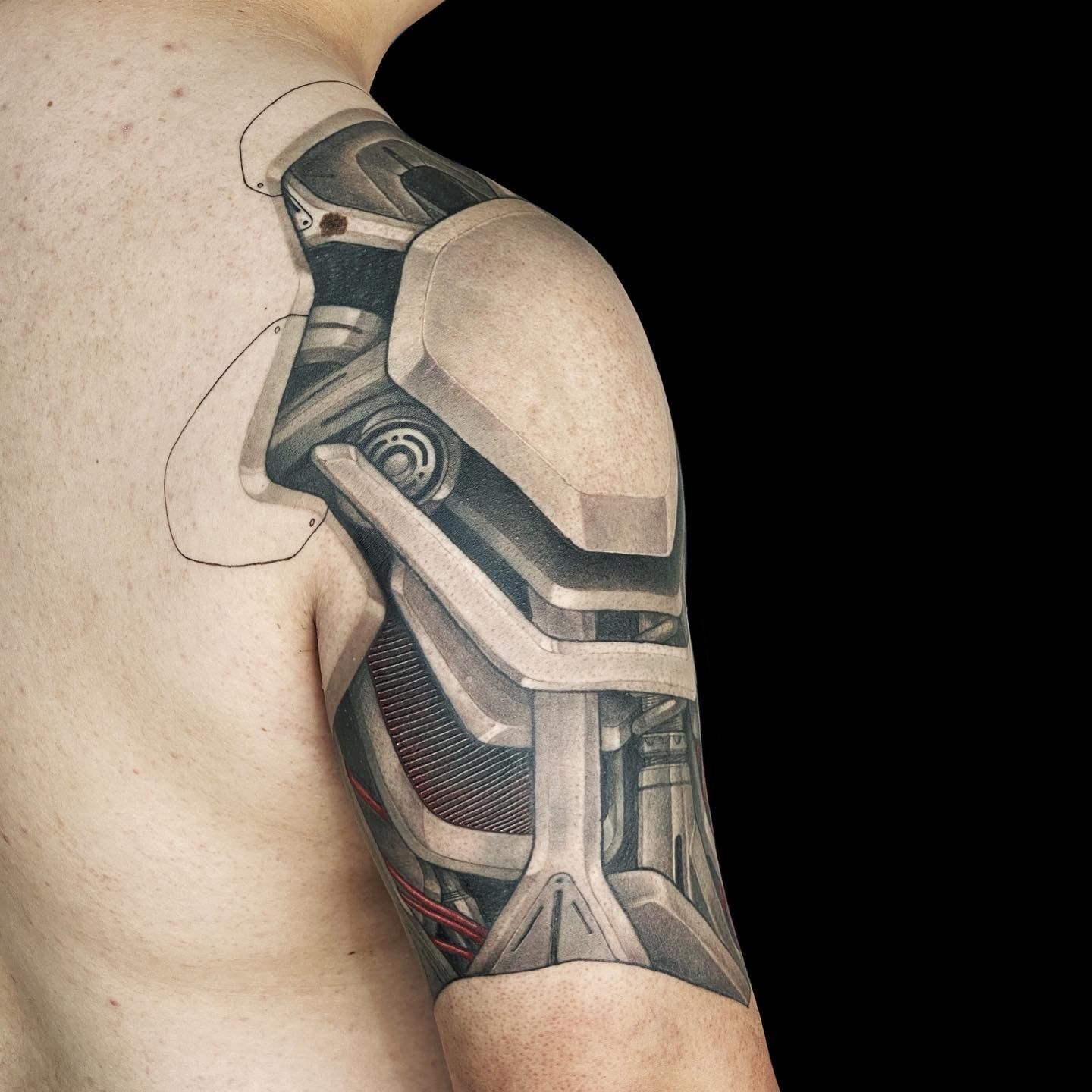 Forearm tattoo, torn skin mechanical arm like the one from the terminator,  coming out of the