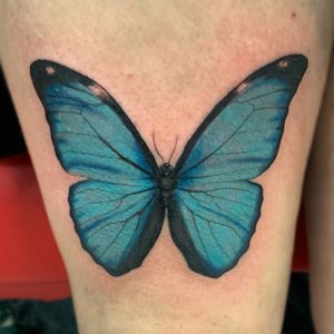 Blue Morpheus Butterfly on a thigh 