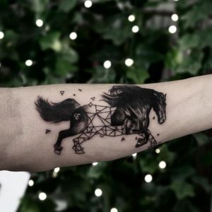 Half realistic half geometric black horse tattoo 