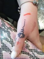 Mini lotus finger tattoo