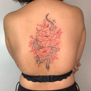 Experience the intricate beauty of a fine line snake intertwined with a vibrant peony flower, expertly tattooed by Galen Bryce (aka Drip Skull).