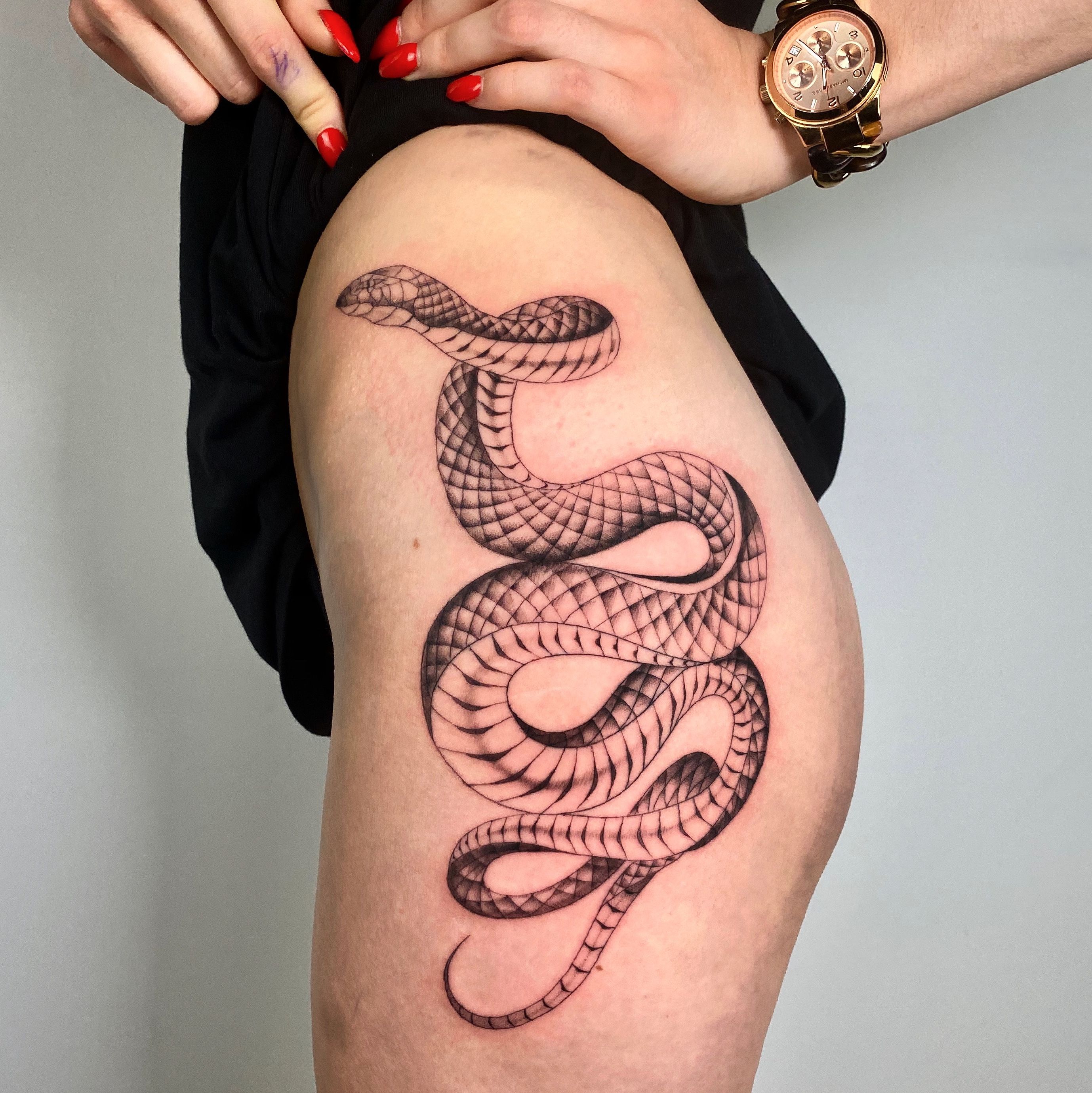 Big snake clasping on a leg while master doing tattoo  concept danger   Stock Photo  167531876