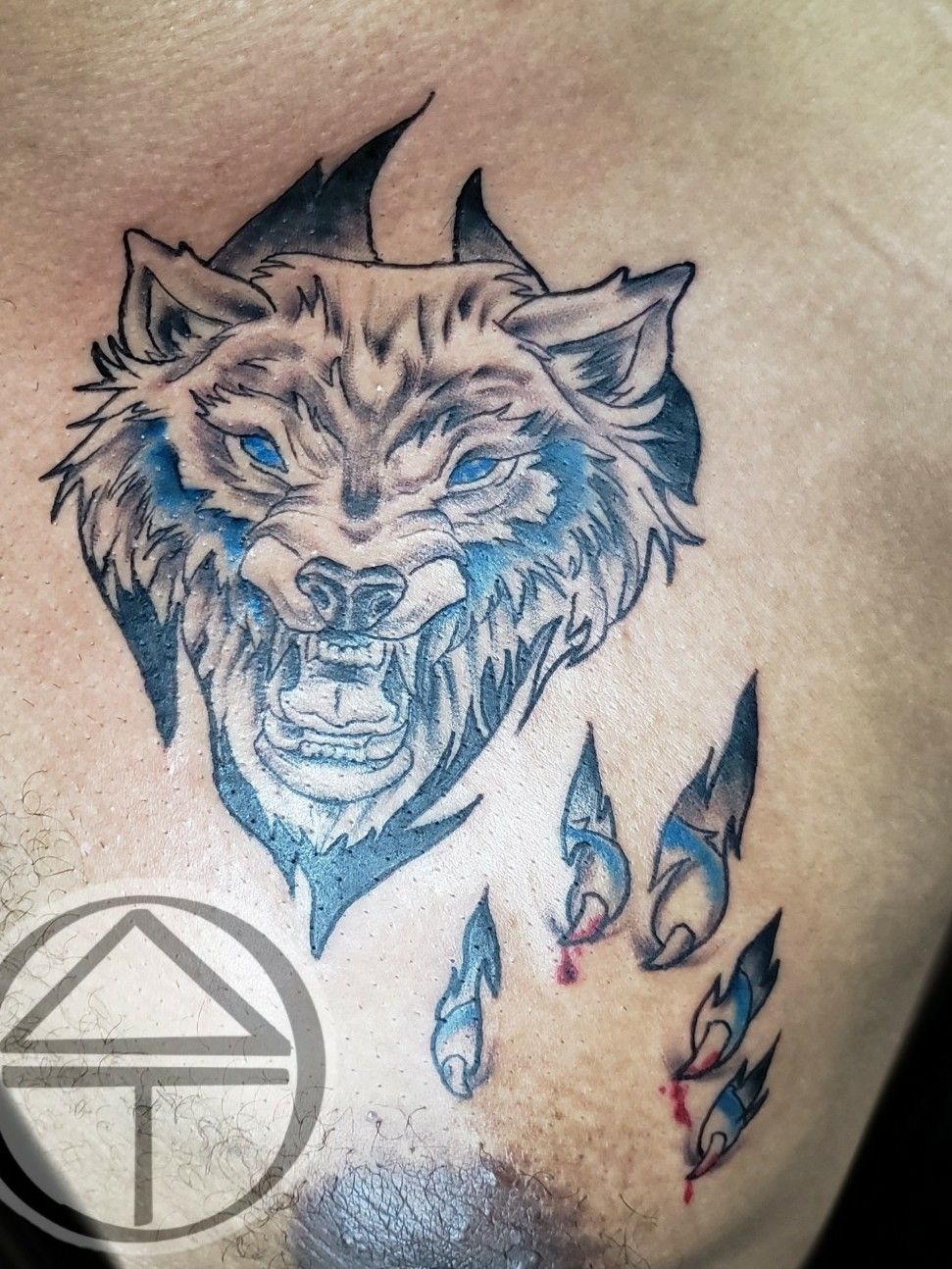 Wolf ripping through skin tattoo - Bronctattooaus.com