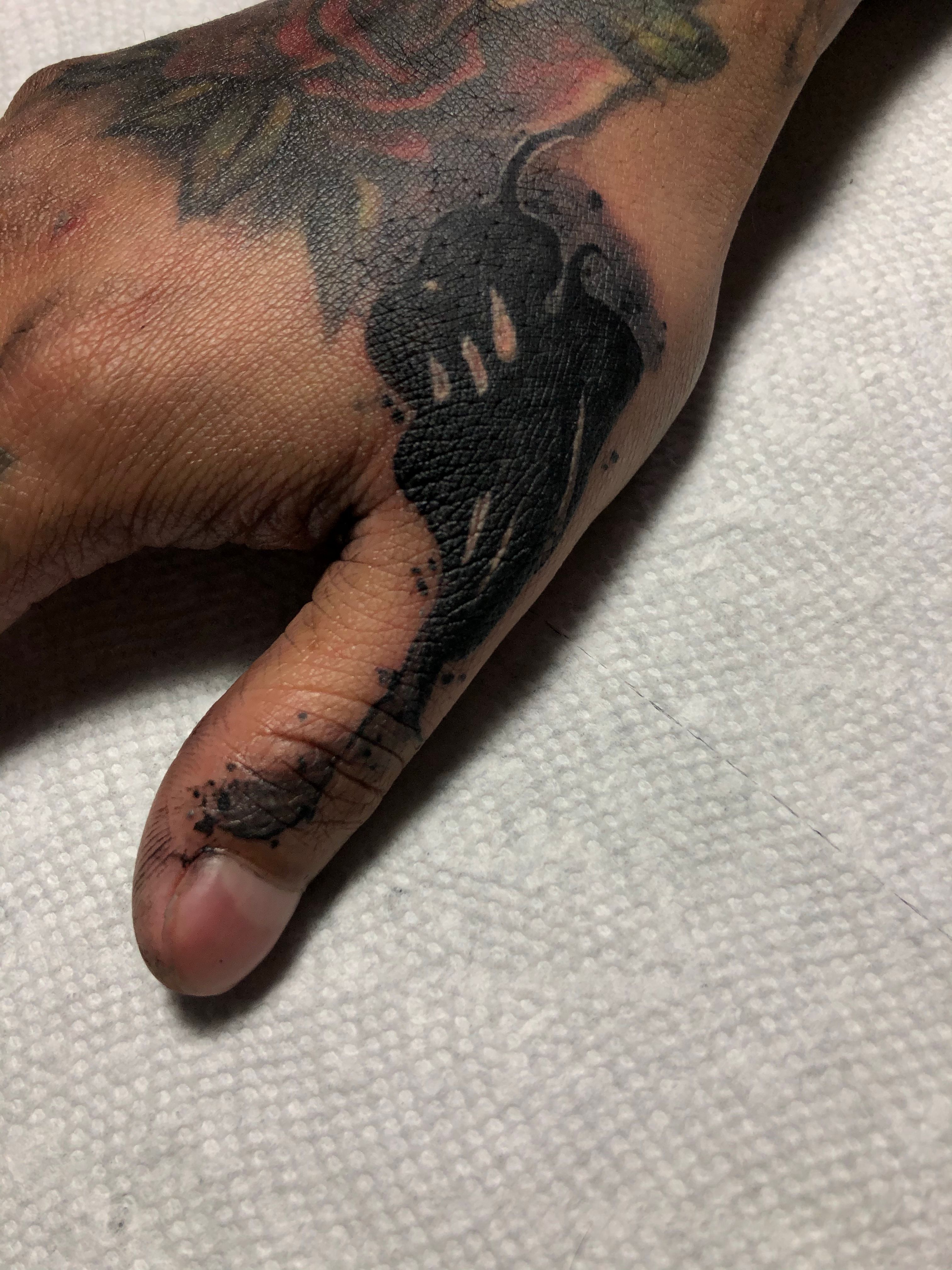 Minimalistic style fist tattoo located on the finger
