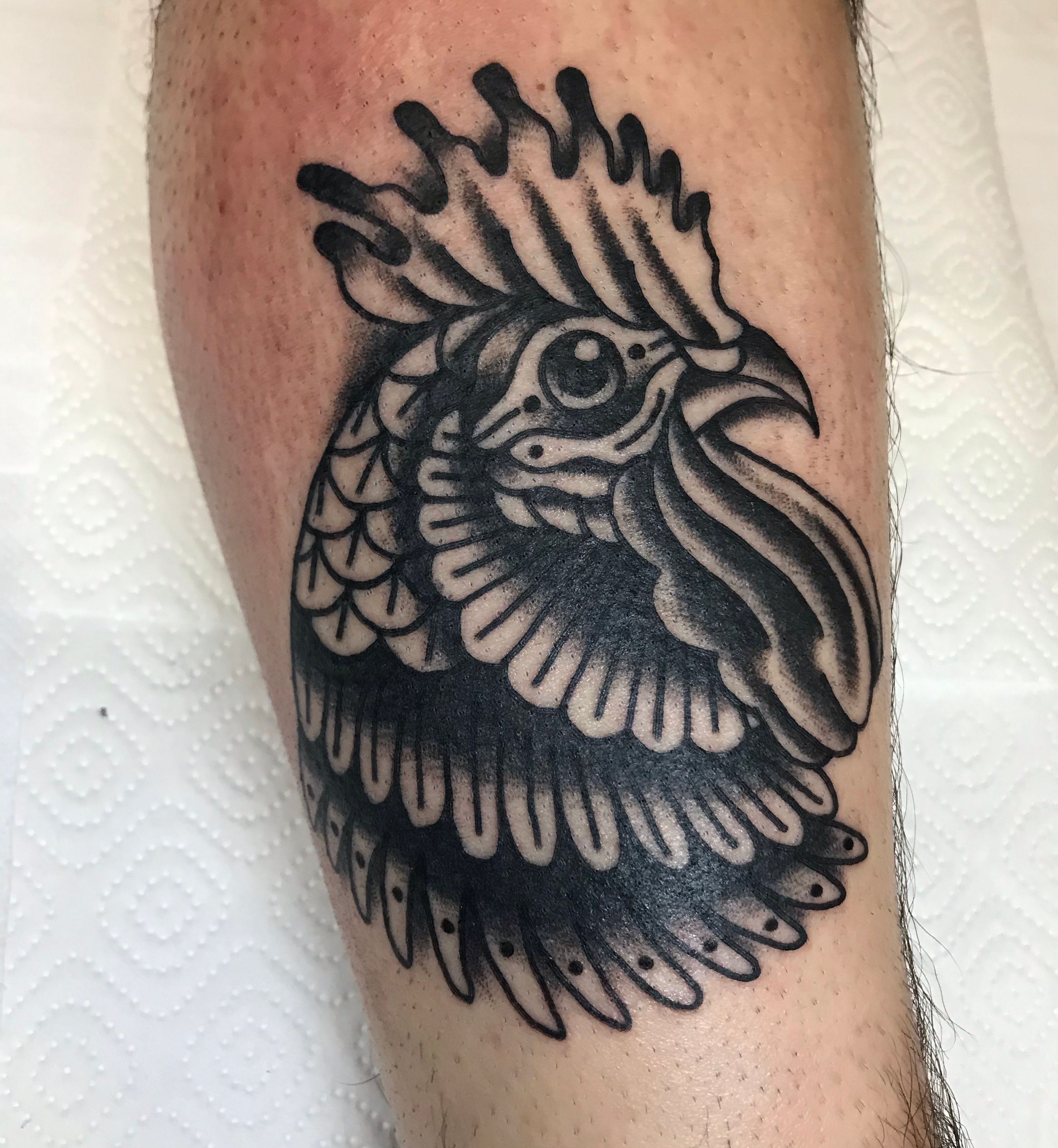 Rooster tattoo located on the thigh blackwork style