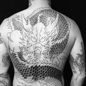 Immerse yourself in the mythical world of Japanese tattoos with this intricate and majestic dragon design by the renowned artist Ami James.