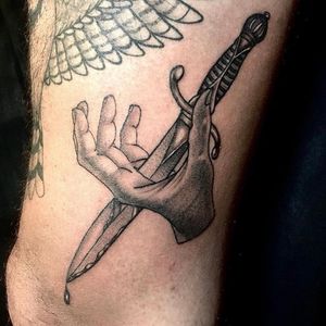 Knife through hand