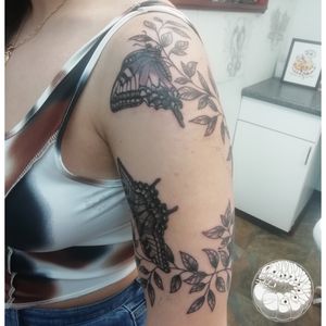 Vine and butterflies wrapping around upper arm