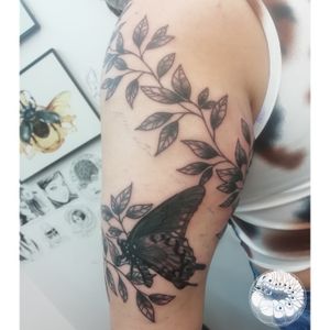 Vine and butterflies wrapping around upper arm