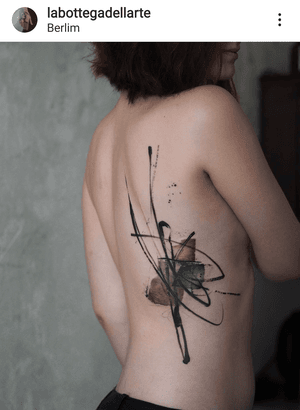 Experience the mind-bending artistry of La Bottega dell'Arte with this surreal blackwork tattoo on your back. Surrealism meets illustrative beauty.