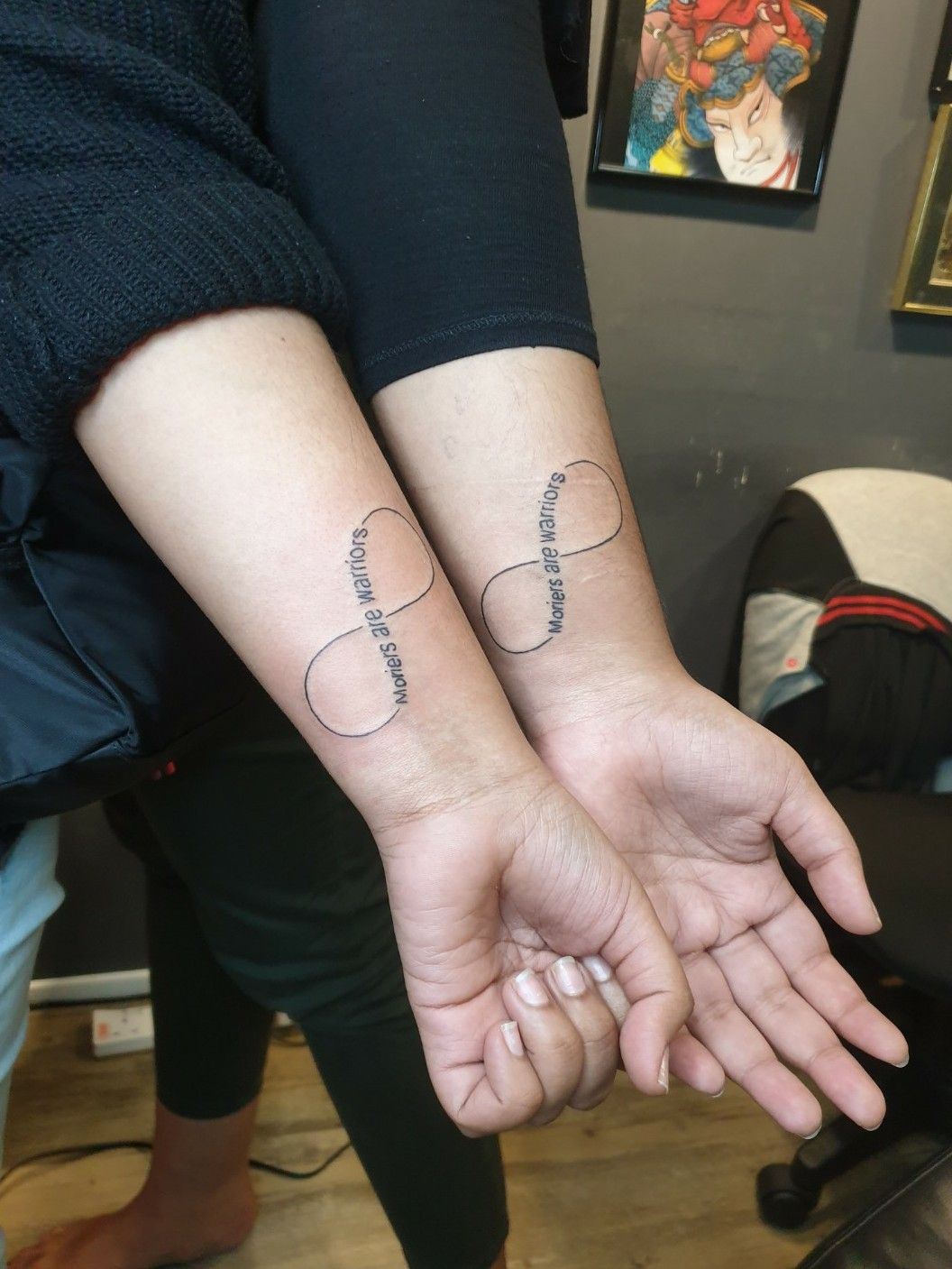 A delicate infinity symbol tattoo with the names michael and matthew  engraved within on Craiyon