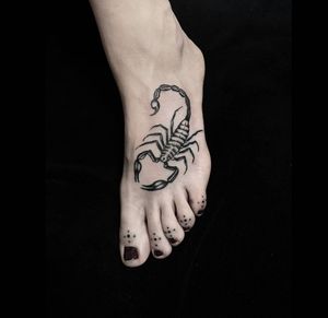 Traditional black and gray scorpion tattoo on foot, done in London, GB. A fierce and stylish design.