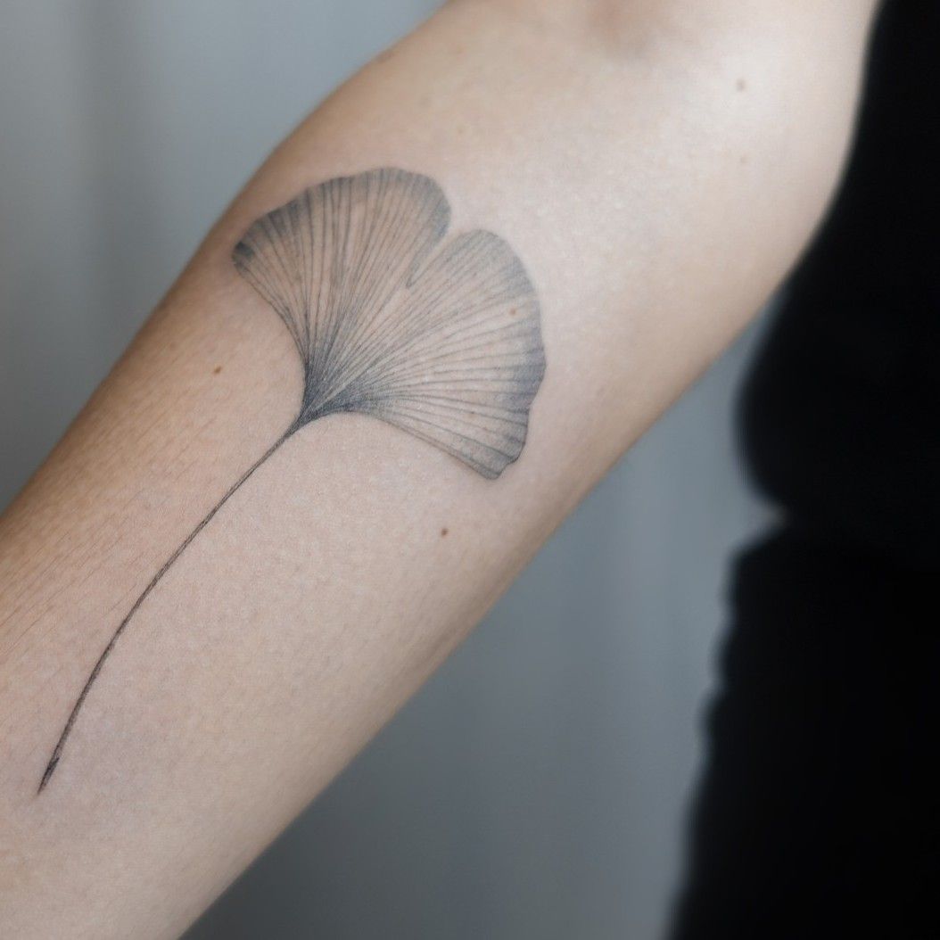 Fine line ginkgo leaf tattoo on the wrist