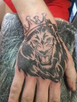 Tribal lion hand tattoo