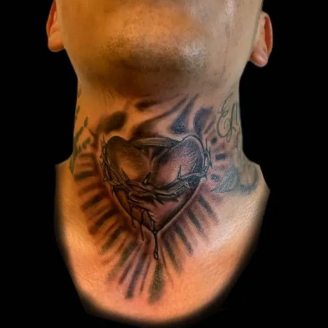 Sacred Heart With Wings Tattoo On Man Upper Back
