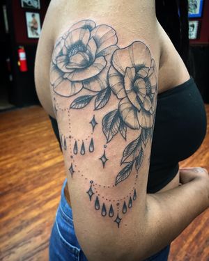 Flowers and ornamental beads. Dot work. On the right arm.