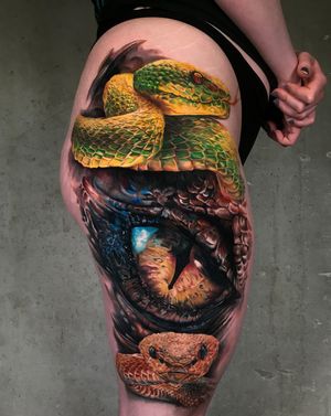 Realistic snakes & dragon's eye tattoo in full color on thigh by tattoo artist Kätlin MalmDone at Studio Malm Tattoo ShopLocation: Tallinn, Estonia Contact: booking@studiomalm.com