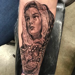 Beautiful tattoo featuring a flower, cross, jesus, woman, tears, and maria by Jake Masri. Perfect for those looking for a meaningful and detailed design.