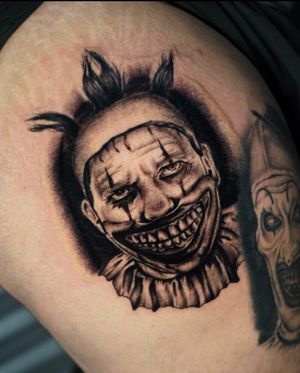 A bold blackwork tattoo of a man in clown makeup, expertly done by Miss Vampira on the upper leg. A unique and eye-catching piece!