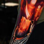 Flaming candle in tattoo