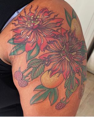 Get a vibrant and detailed orange flower tattoo on your upper arm by the talented Brigid Burke!