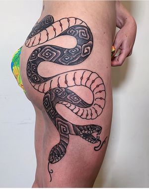 Brigid Burke's bold blackwork snake design on upper leg combines traditional and illustrative styles.