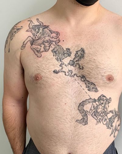 Unique blackwork and fine-line illustrative tattoo featuring fish and bull horns on the chest by the talented artist Brigid Burke.