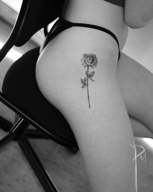 fineline rose tattoo on side hip