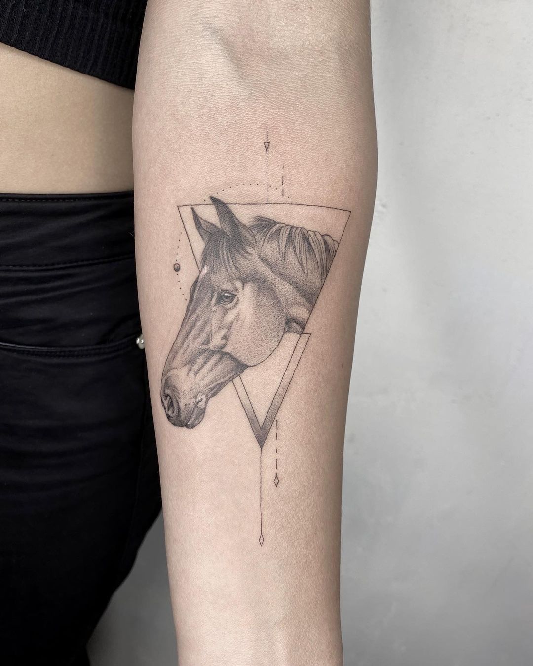 Fine line horse tattoo on the left side ribcage