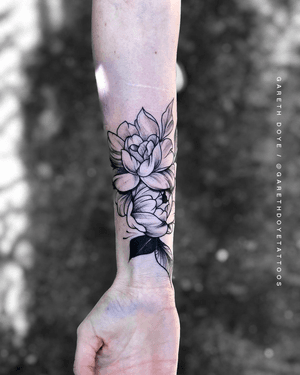 Exquisite blackwork peony by Gareth Doye, a stunning addition to your forearm. Bold and intricate illustration style.