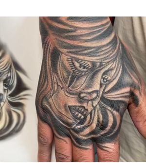 Hand face tattoo Chicano 