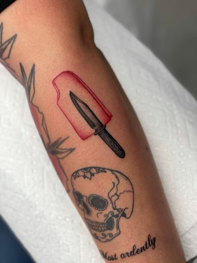 Unique and eye-catching blackwork and neo-traditional style tattoo featuring a knife and ice cream design by Miss Vampira. Perfect for bold statement piece.