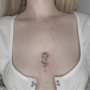 Mini rose mid chest. #chest #chesttattoo #minirose #minitattoo #smalltattoo #rose #black&grey #fineline