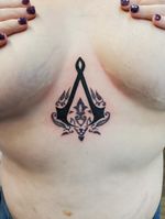 Assassin creed tattoo on sternum