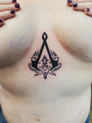 Assassin creed tattoo on sternum