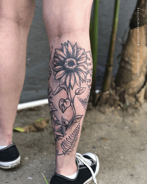 Unique blackwork design by Gareth Doye, featuring a detailed flower motif on the lower leg. Perfect for nature lovers.