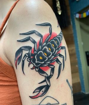 Get inked with a fierce scorpion design on your upper arm, created by the talented artist Felipe Reinoso. Embrace the power and strength of this traditional style tattoo.