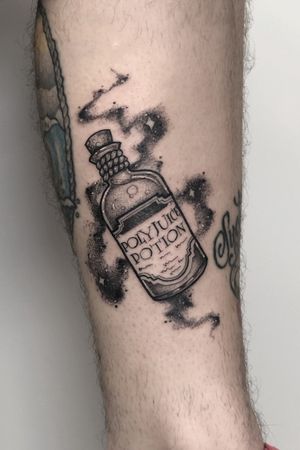 Get a striking black and gray poison motif tattoo on your lower leg in London, GB. Unique and edgy design.