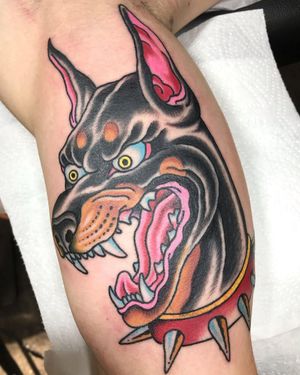Get a timeless and stylish neo traditional dog tattoo with collar design on your upper arm in London, GB.