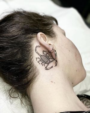 Check out this stunning black and gray scorpion tattoo done by talented artist Sophie Rose Hunter, perfectly placed behind the ear.