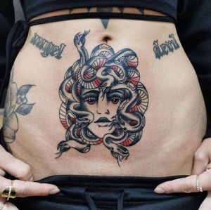 Get a stunning blackwork snake and woman illustrative tattoo on your stomach in Los Angeles.