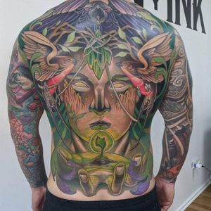 This illustrative tattoo features a colorful bird, tree, woman, and seed motif, creating a dynamic and unique design that will stand out on your back. Perfect for tattoo enthusiasts in Los Angeles!