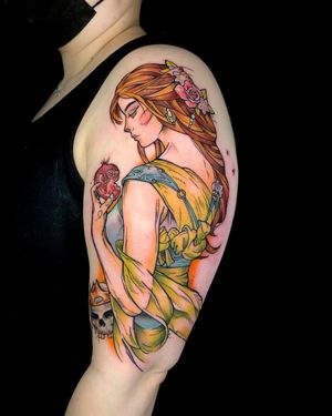 A stunning neo traditional tattoo of a woman with a pomegranate motif on the upper arm by artist Sandro Secchin.