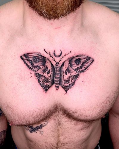 Get a stunning black and gray chest tattoo of a moth intertwined with a skull by renowned artist Sandro Secchin. Perfect combination of beauty and darkness.